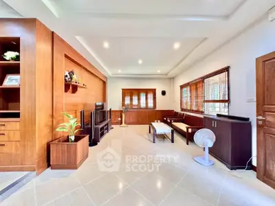 Spacious living room with modern wooden decor and ample natural light