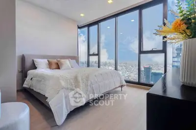 Luxurious bedroom with panoramic city views and modern decor