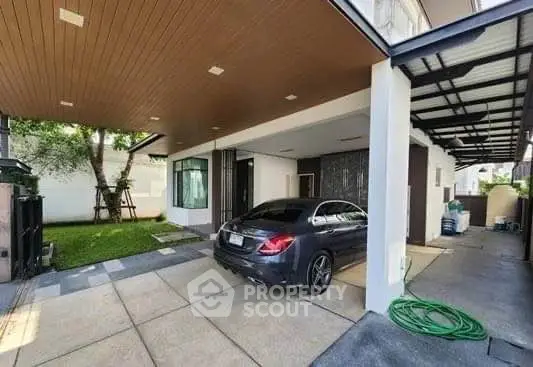 Modern home with sleek carport and lush garden, perfect blend of luxury and nature.