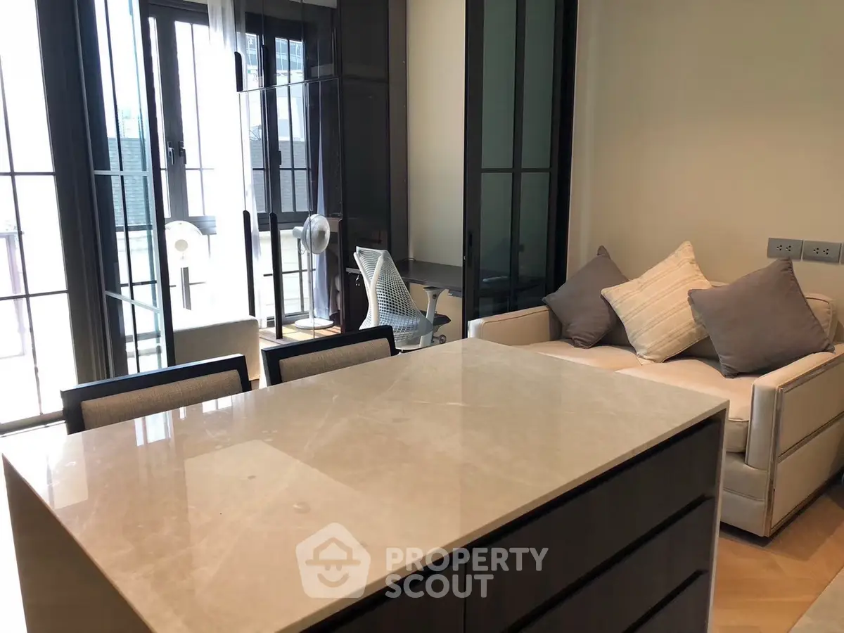 Modern living room with sleek furniture and large windows