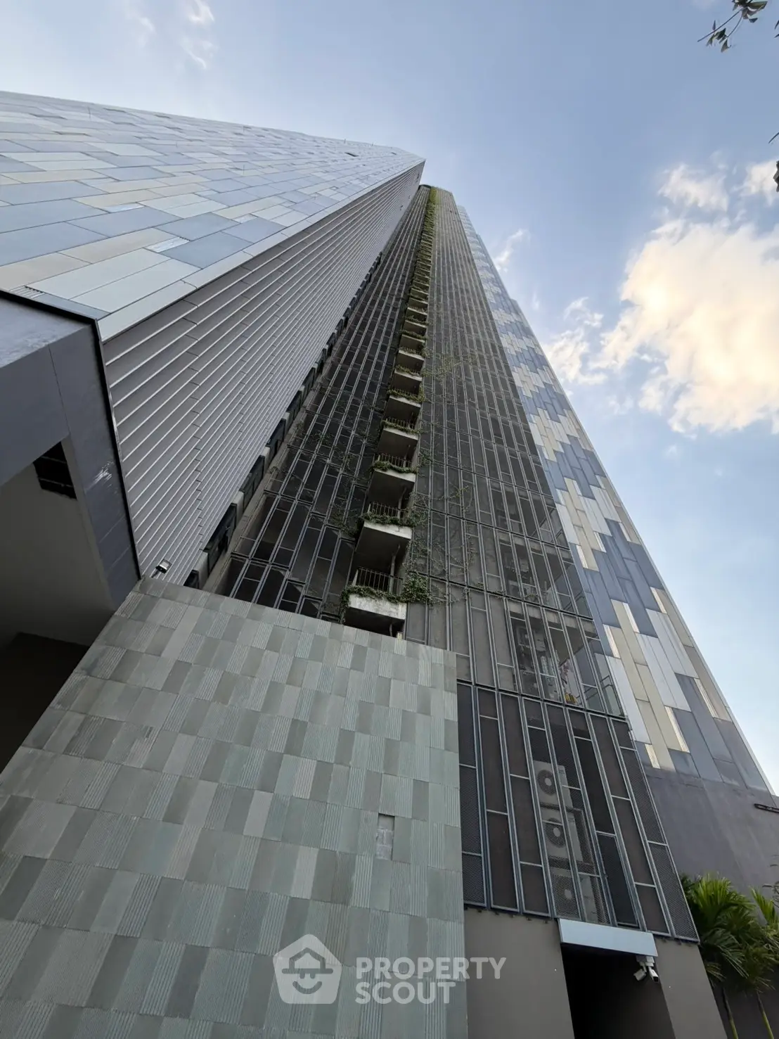 Stunning modern high-rise building with sleek architectural design and lush vertical greenery.