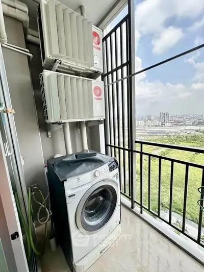 High-rise balcony with washing machine and city view, perfect for urban living convenience.