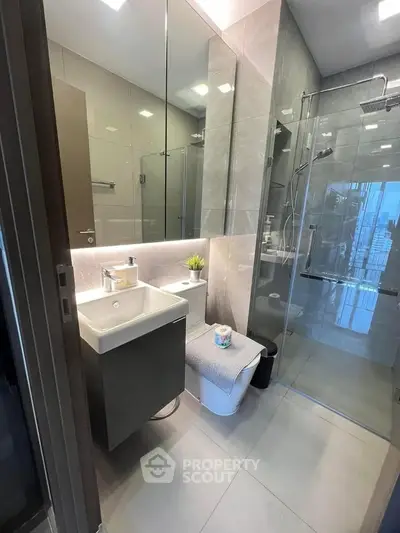 Modern bathroom with sleek design, glass shower, and stylish vanity in a contemporary apartment.