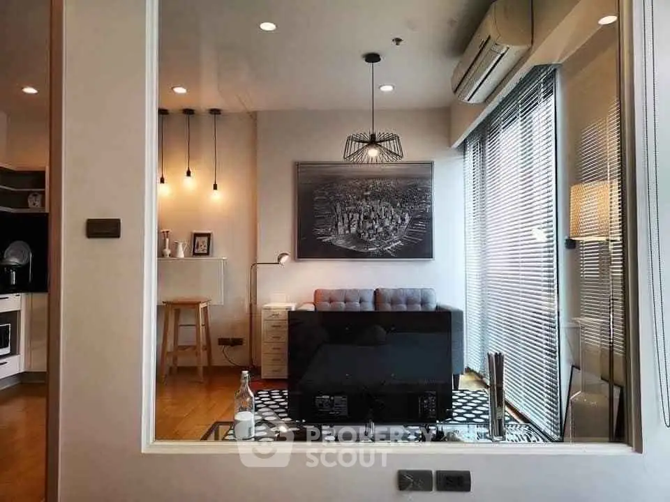 Modern living room with stylish decor and large windows in a contemporary apartment.