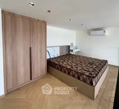 Spacious bedroom with modern wooden wardrobe and air conditioning unit