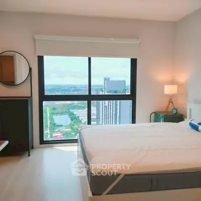 Modern bedroom with large window offering stunning city view, stylish decor, and cozy ambiance.