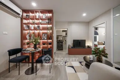 Modern living room with stylish decor and open layout, featuring a cozy dining area and elegant shelving.