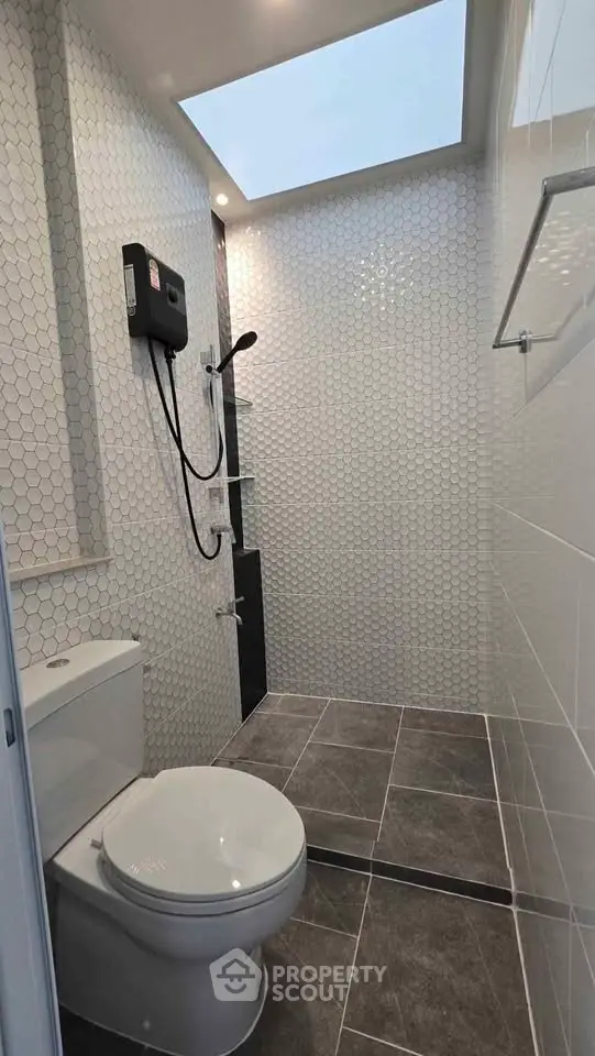 Modern bathroom with skylight and sleek shower design