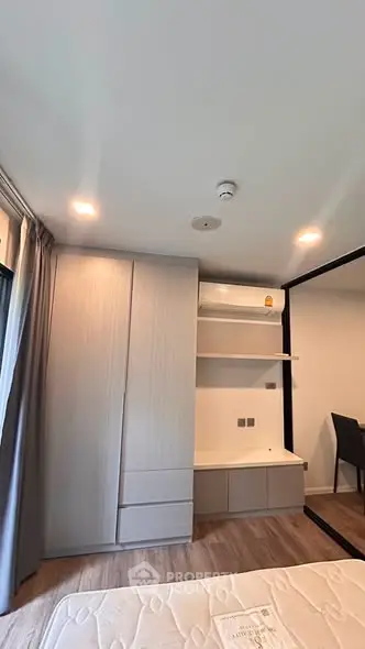 Modern bedroom with built-in wardrobe and sleek design in a contemporary apartment.