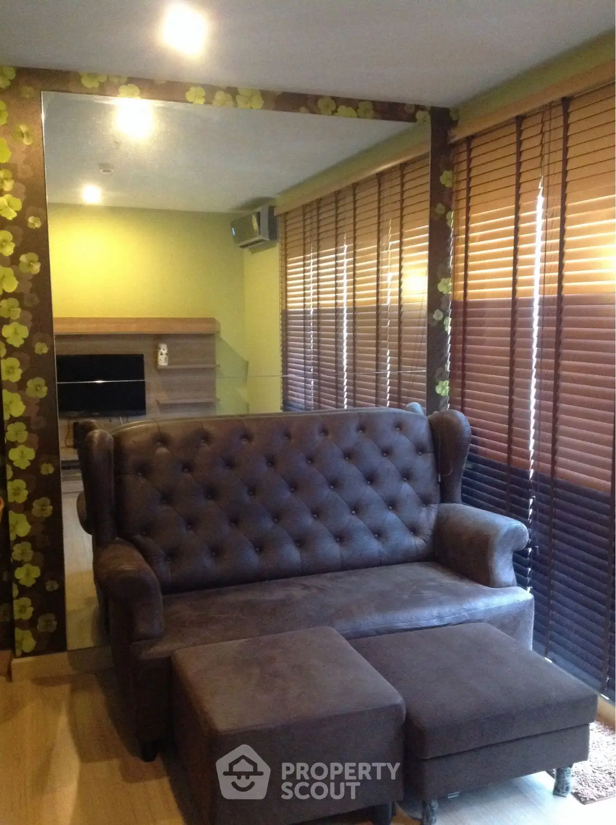 Cozy living room with elegant brown sofa and stylish blinds