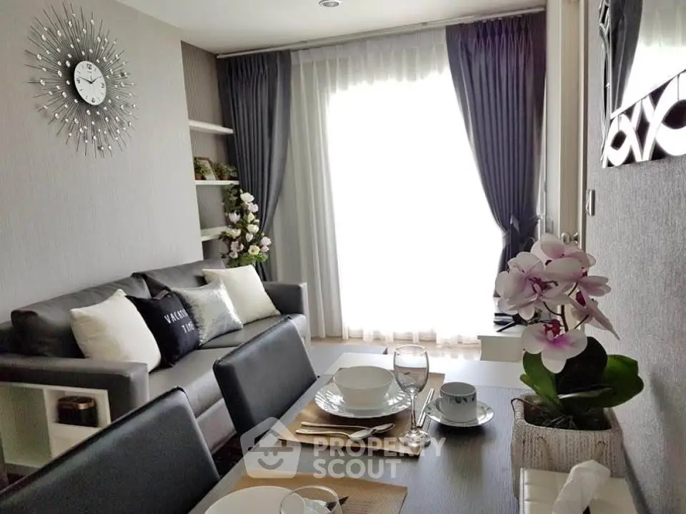 Modern living room with stylish decor and natural light, featuring a cozy sofa and elegant dining setup.