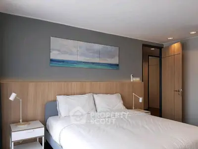Modern bedroom with stylish decor and cozy ambiance, featuring a comfortable bed and elegant lighting.
