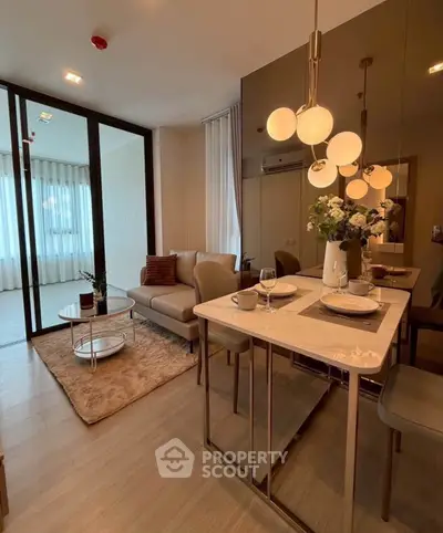 Modern living room with elegant dining area and stylish lighting in a cozy apartment.