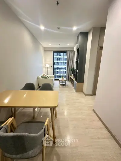 Modern living room with stylish furniture and balcony view in a contemporary apartment.