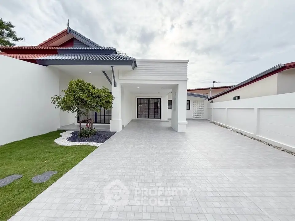 Modern single-story home with spacious driveway and landscaped garden