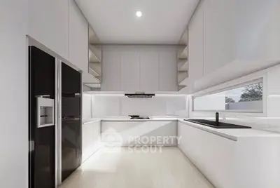Modern kitchen with sleek white cabinetry and built-in appliances in a contemporary home.