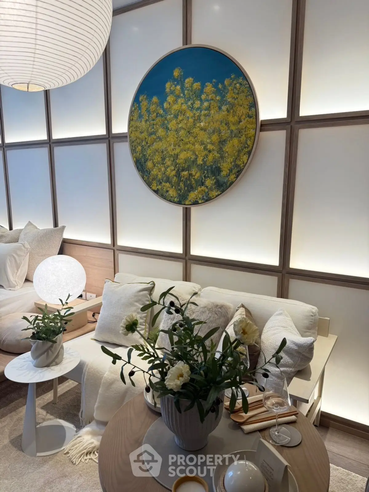Stylish living room with modern decor and floral artwork, cozy seating and ambient lighting.