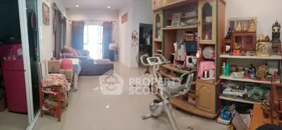 Spacious living room with exercise equipment and ample natural light
