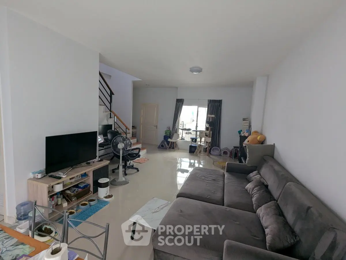 Spacious living room with modern furniture and open layout, perfect for family gatherings.