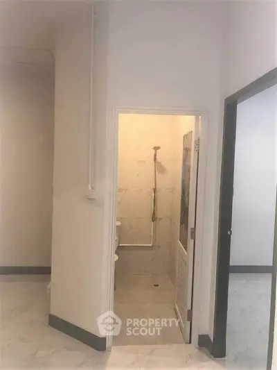 Compact bathroom with shower in modern apartment