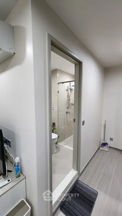 Modern bathroom entrance with sleek design and neutral tones
