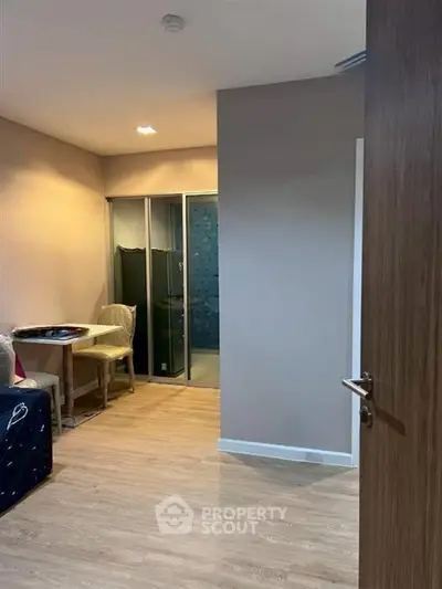 Cozy interior view of a modern apartment with wooden flooring and stylish furniture.