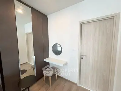 Modern minimalist bedroom with sleek wardrobe and vanity area