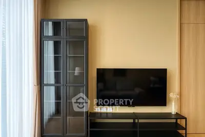 Modern living room with sleek TV stand and glass cabinet