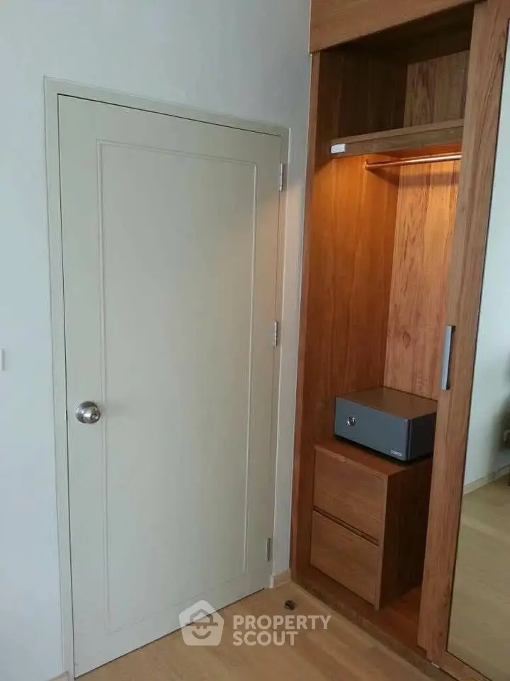 Modern bedroom with built-in wooden wardrobe and safe
