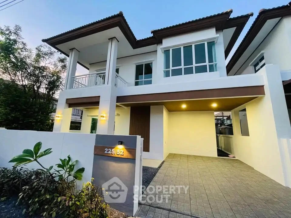 Stunning modern two-story house with elegant facade and well-lit entrance, perfect for family living.