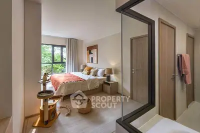 Spacious bedroom with large window and modern decor, featuring a cozy bed and natural light.