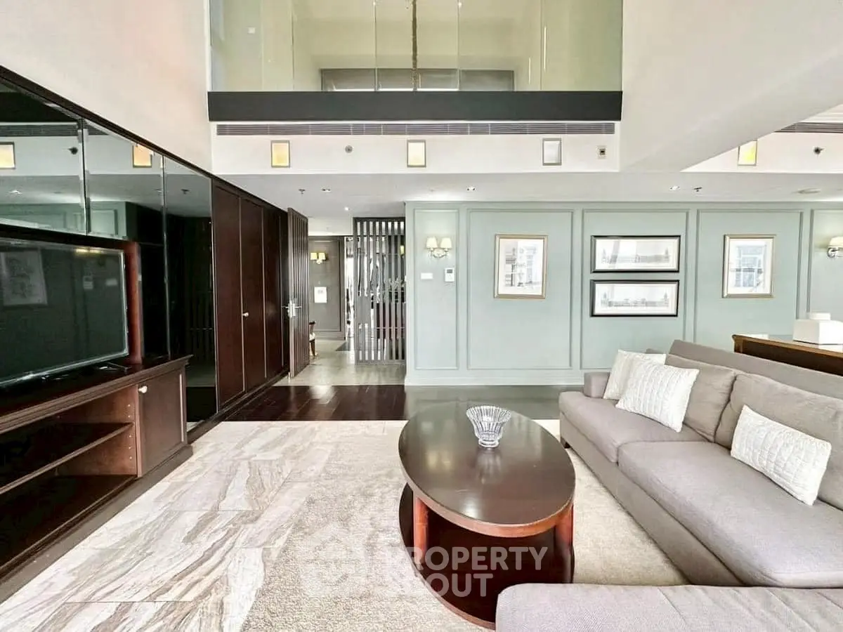 Luxurious living room with modern decor and spacious layout, featuring elegant furniture and stylish design.