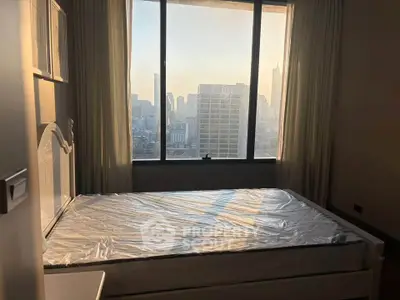 Spacious bedroom with city view and large window, perfect for urban living.