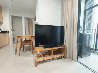 Modern living room with TV and dining table in a bright apartment