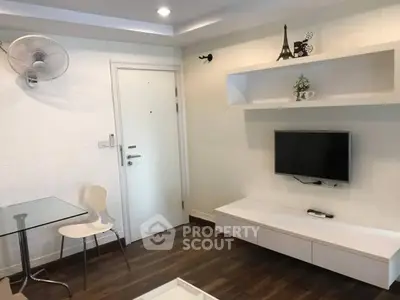 Modern living room with wall-mounted TV and minimalist decor