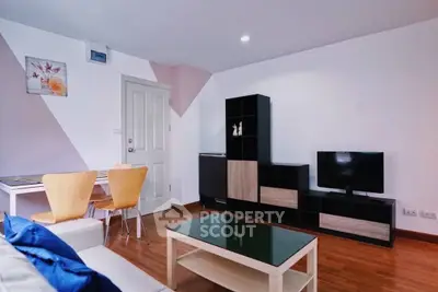 Modern living room with stylish furniture and entertainment center in a cozy apartment.