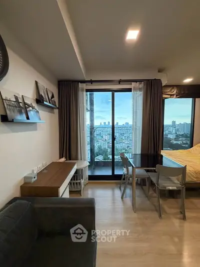 Modern living room with city view, featuring stylish decor and floor-to-ceiling windows.