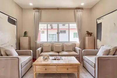Charming living room with cozy sofas and natural light, perfect for relaxation and entertaining guests.