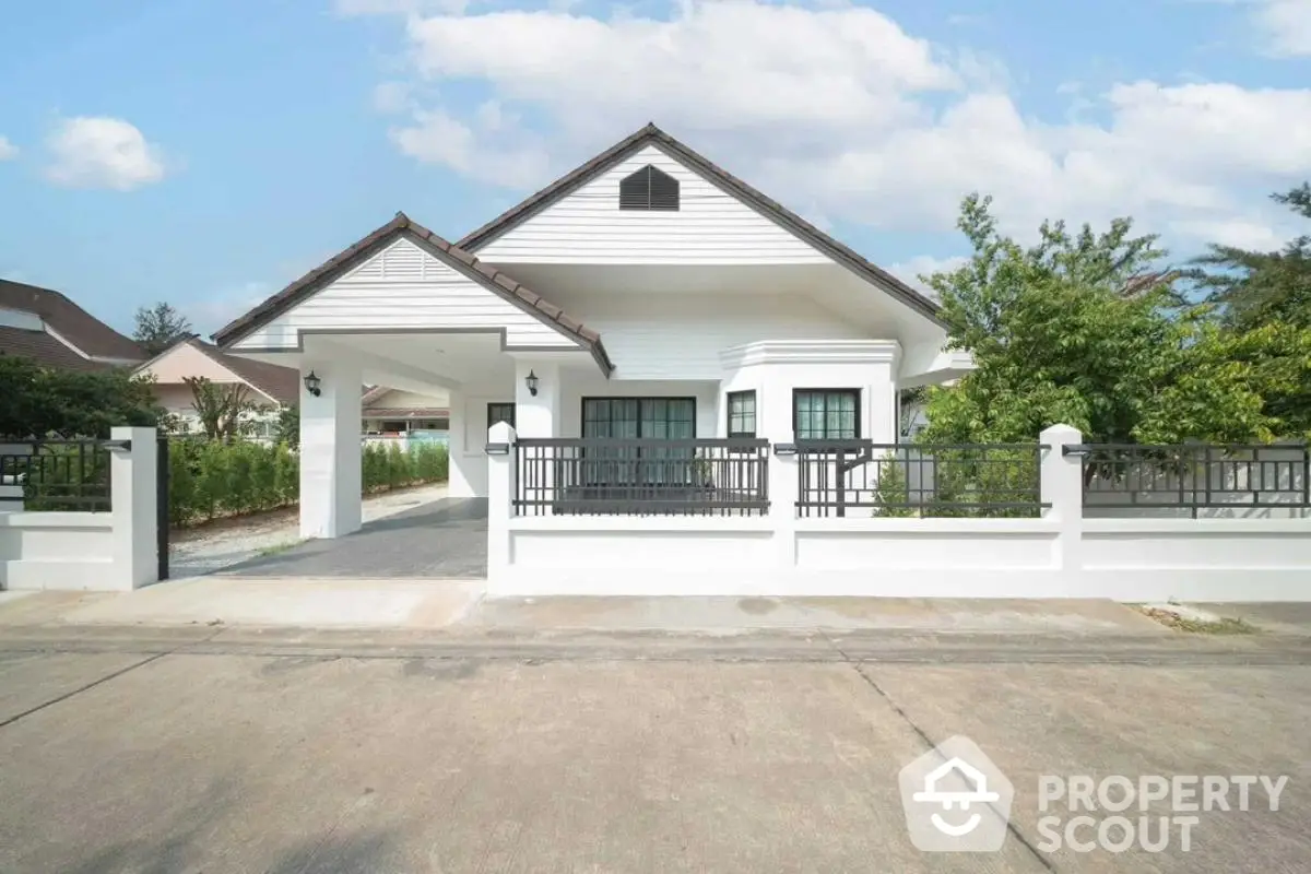 Charming single-story house with modern design and spacious driveway in serene neighborhood.