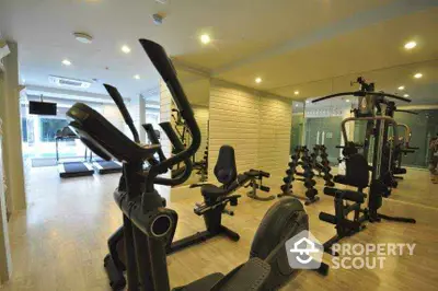 Modern gym with state-of-the-art fitness equipment in luxury residential building.