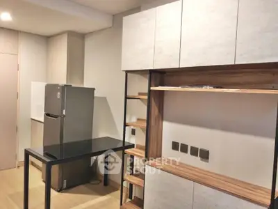 Modern kitchen with sleek cabinetry and stainless steel fridge