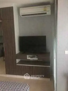 Modern living room with air conditioning and sleek TV unit, perfect for cozy entertainment.