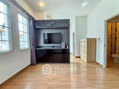 Spacious modern living room with sleek TV unit and large windows