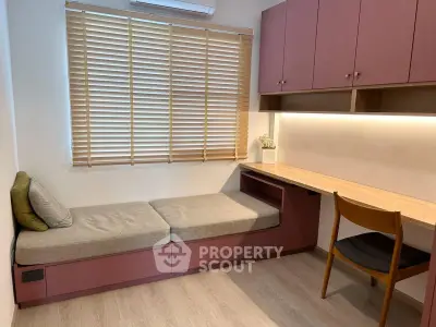 Modern study room with built-in desk and seating, featuring stylish cabinetry and natural light.