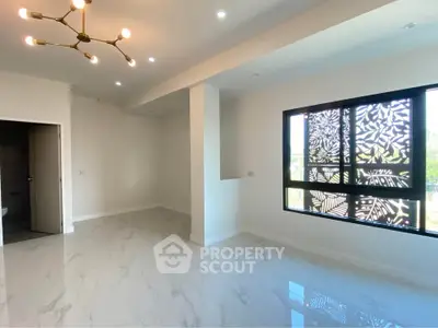 Spacious modern living room with elegant lighting and large window