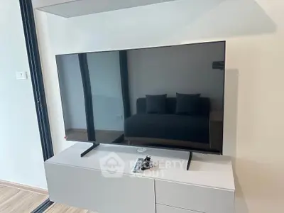 Modern living room with sleek TV setup and stylish furniture