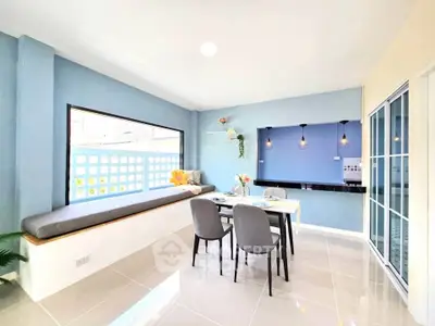 Bright and modern dining area with large window and stylish decor