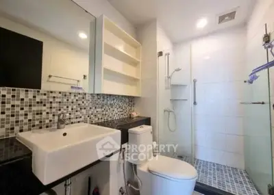 Modern bathroom with sleek fixtures and stylish tile design in a contemporary home.