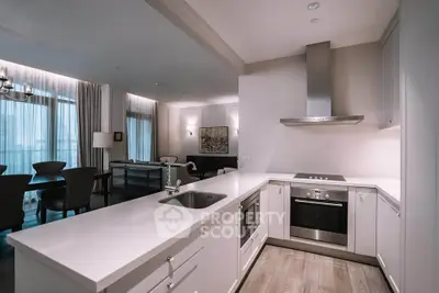 Modern open kitchen with sleek design and integrated appliances in a stylish apartment.