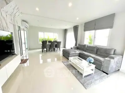 Spacious modern living room with elegant dining area and large windows